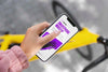 Woman Using Mock-Up Smartphone Outdoors While On Bicycle Psd