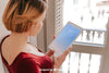 Woman Using Tablet In Front Of Window Psd
