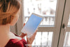 Woman Using Tablet In Front Of Window Psd