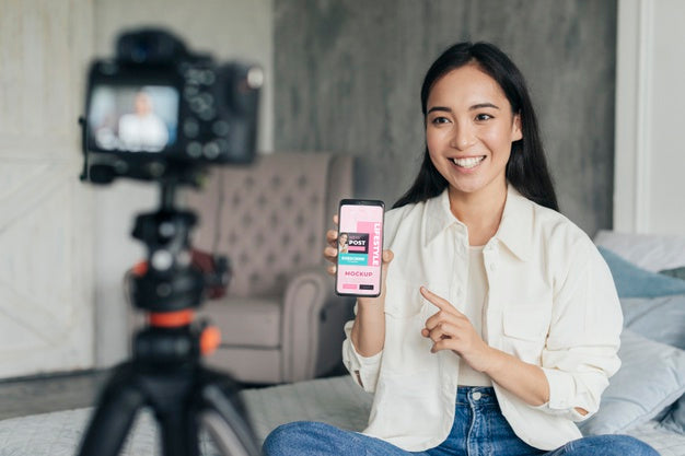 Woman Vlogger Holding A Phone Mock-Up Psd