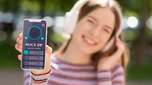 Woman Wearing Headphones And Holding Phone With Music App Mock-Up Psd