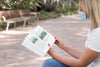 Woman Wearing Mask On Street Reading Book Psd