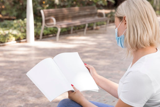 Woman With Mask On Street Reading Book Psd