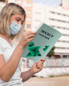 Woman With Mask Reading Book On Street Psd