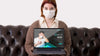 Woman With Masks Holding Laptop While Sitting On The Couch Psd