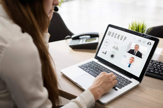 Woman Working On Her Laptop At Work Psd