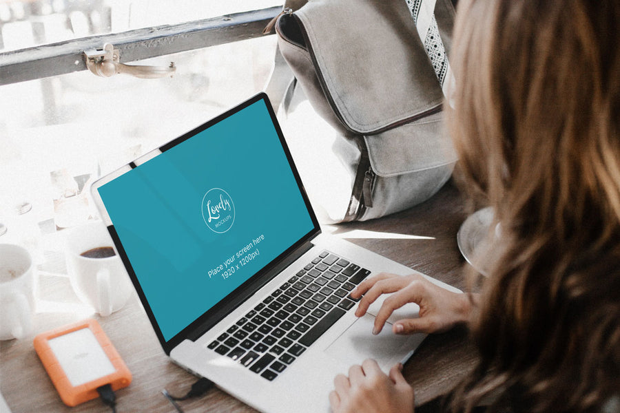 Young Woman Working On Her New Macbook Pro PSD Mockup