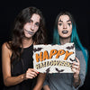 Women Holding Paper With Halloween Lettering Psd