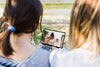 Women Looking At Tablet Mockup In Park Psd