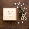 Wooden Box Mockup Next To Flowers Psd