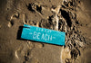 Wooden Sign On The Sand