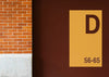 Yellow Signboard Mockup On A Brown Wall Psd