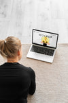 Yoga Instructor Looking At A Laptop Mock-Up Psd
