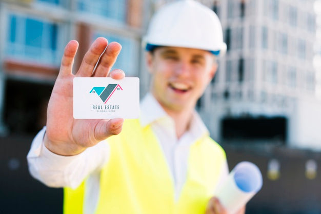 Young Architect Holding A Business Card Psd