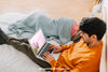 Young Couple With Laptop In Bed Psd