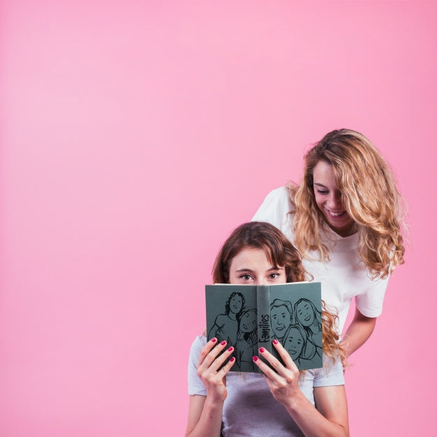 Young Girls Holding Book Cover Mockup Psd