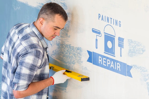 Young Handyman Measuring The Wall Psd