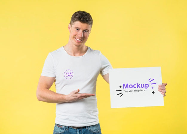 Young Man Standing And Showing A Mock-Up Psd