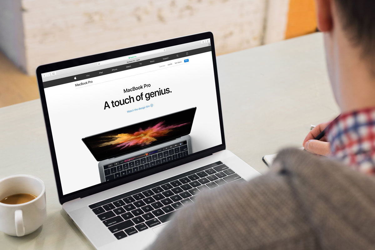 Young Man Working on his 15" Macbook Pro Mockup