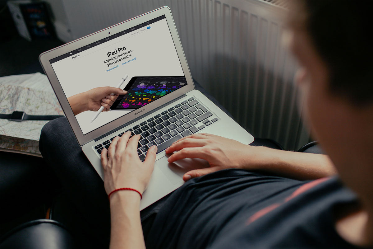 Young Man Working on his Macbook Air Mockup
