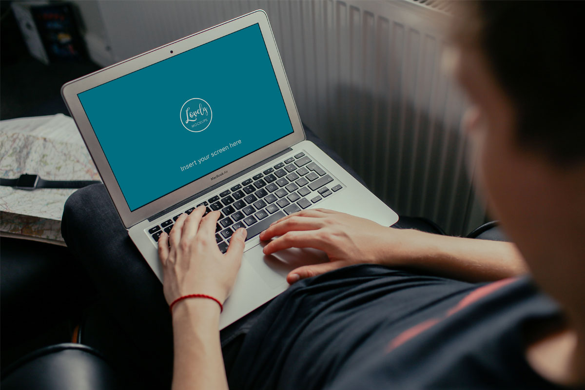 Young Man Working on his Macbook Air Mockup
