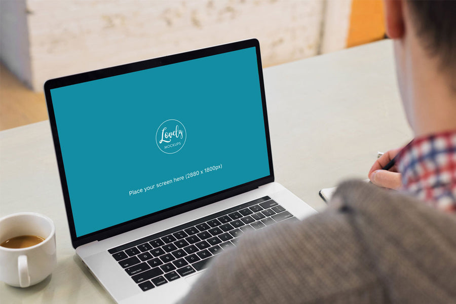 Young Man Working on his 15" Macbook Pro Mockup