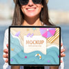 Young Woman Holding A Mock-Up Tablet Psd