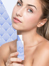 Young Woman Holding A Skincare Product Mock-Up Psd
