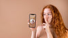 Young Woman Holding A Smartphone Mock-Up Psd