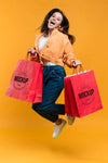 Young Woman Jumping And Holding Shopping Bags Mock-Up Psd