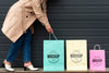 Young Woman Standing Next To Shopping Bags Psd