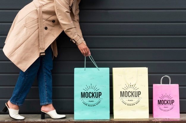 Young Woman Standing Next To Shopping Bags Psd